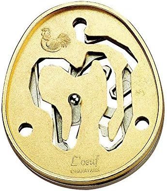 Golden Color hanayama cast metal puzzle assembled on a work bench